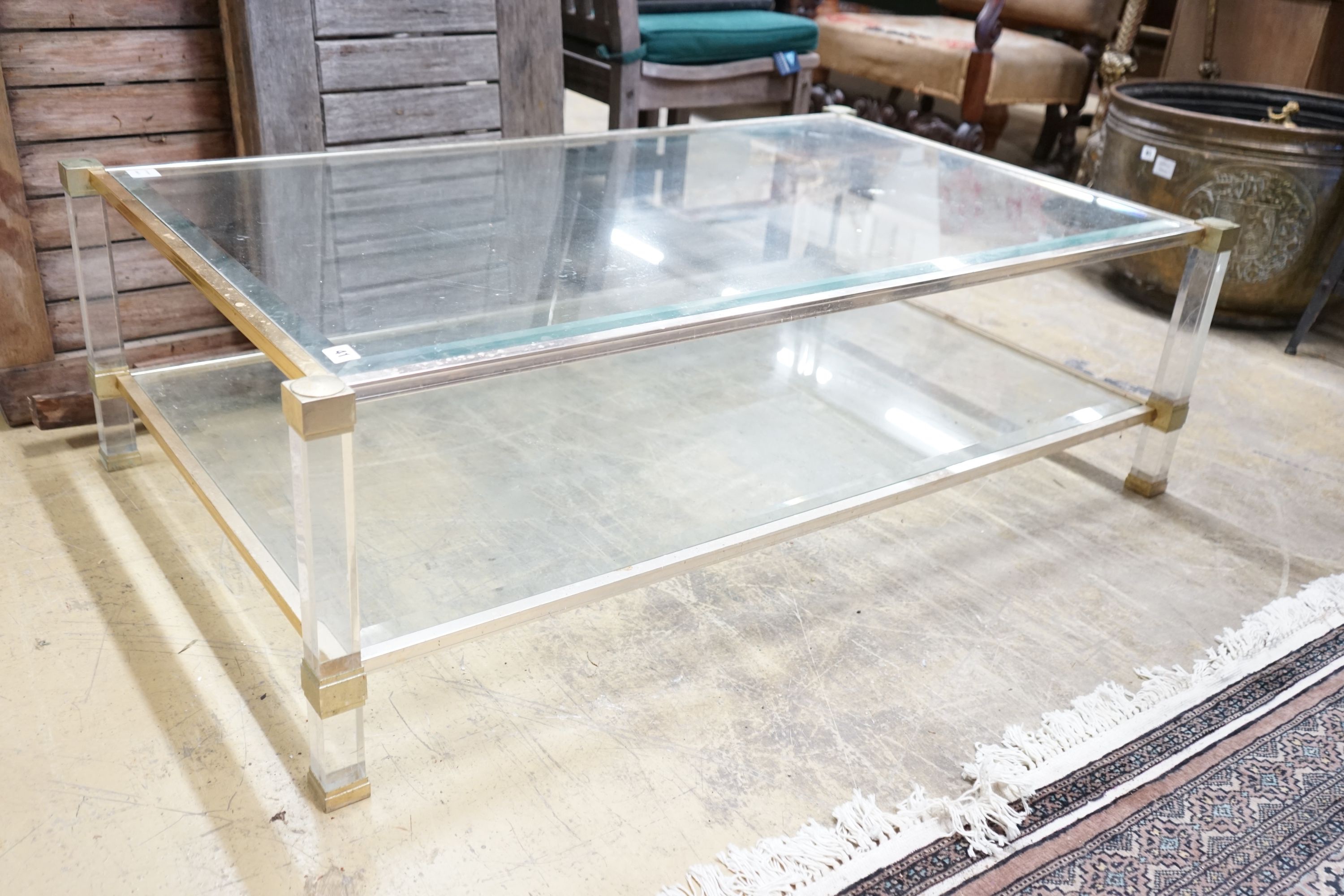 A contemporary metal and bevelled glass two tier coffee table, width 128cm, depth 77cm, height 40cm